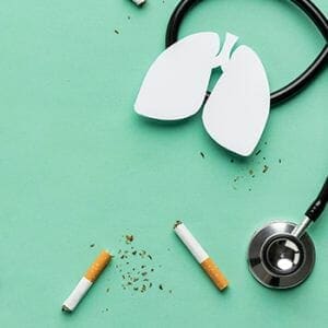 Stethoscope with a cut out of lungs and 2 piece of cigarette