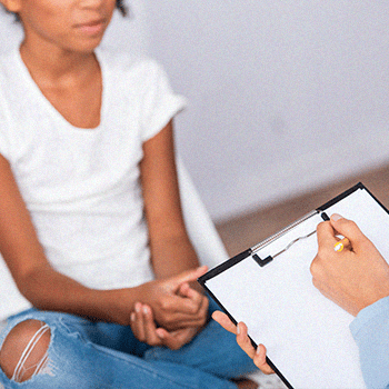 A patient being interviewed by a medical professional before a drug test