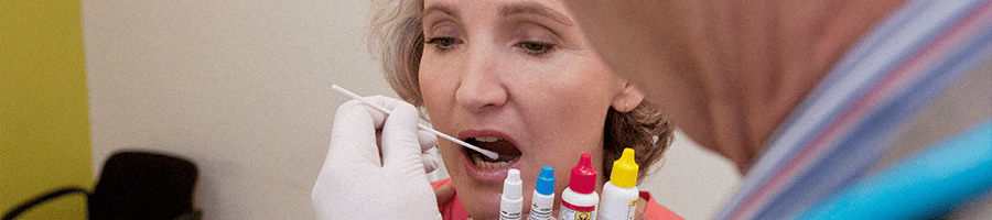An old patient doing a swab test with different samples