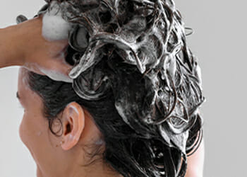 A woman scrubbing her hair