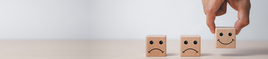 wood blocks with sad and happy faces