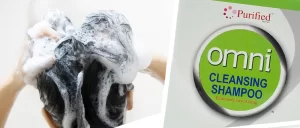 Woman putting shampoo on hair with Omni Cleansing Shampoo