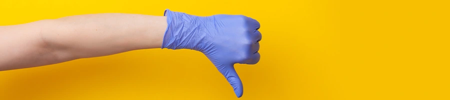 hand with gloves in a thumbs down