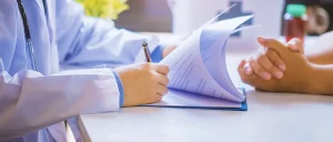 a doctor checking a person's fingernails for a drug test