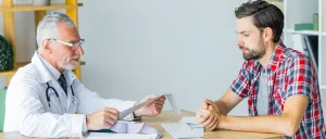A man and a doctor discussing the pre-employment drug screening