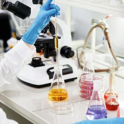 A person mixing chemicals in a laboratory
