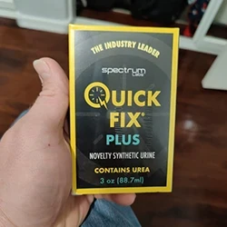 A person holding the box of Quick Fix to check the batch number